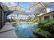Screened-in pool area with outdoor seating, lush landscaping, and covered pool at 3416 Fairfield Trl, Clearwater, FL 33761