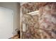 Modern shower featuring a glass door, shower head, and a convenient towel rack, complemented by ceramic tile at 3416 Fairfield Trl, Clearwater, FL 33761
