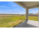 View from the covered back patio of the property showcasing the expansive backyard space with lush green grass at 35320 Spruce Knob Ct, Dade City, FL 33525