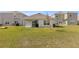 The home features a covered back patio and well maintained lawn at 35320 Spruce Knob Ct, Dade City, FL 33525