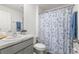 Bathroom with patterned shower curtain and neutral color scheme at 35320 Spruce Knob Ct, Dade City, FL 33525