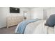 Bedroom boasts a large dresser, mounted TV, and ample natural light at 35320 Spruce Knob Ct, Dade City, FL 33525