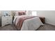 Well-lit bedroom featuring a comfy bed, side table, and carpeted floor at 35320 Spruce Knob Ct, Dade City, FL 33525