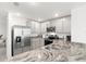 Close-up on the modern kitchen featuring granite countertops, stainless steel appliances and ample cabinet space at 35320 Spruce Knob Ct, Dade City, FL 33525