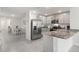Modern kitchen and dining area with stainless steel appliances, granite countertops, and ample cabinet space at 35320 Spruce Knob Ct, Dade City, FL 33525