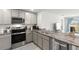 Well-equipped modern kitchen with stainless steel appliances, granite countertops, and plenty of counter space at 35320 Spruce Knob Ct, Dade City, FL 33525