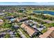 An attractive aerial view of the property showcases a well-maintained community with a swimming pool and scenic golf course at 4006 Crockers Lake Blvd # 212, Sarasota, FL 34238