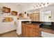 Well-lit bathroom with wood cabinets, granite countertops, a decorative mirror and convenient built in storage shelving at 4006 Crockers Lake Blvd # 212, Sarasota, FL 34238