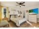 Bright bedroom featuring a decorative rug, outdoor access, and ceiling fan at 4006 Crockers Lake Blvd # 212, Sarasota, FL 34238