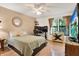 Comfortable bedroom featuring a ceiling fan, a large window, and a playful dresser with a painted starfish design at 4006 Crockers Lake Blvd # 212, Sarasota, FL 34238