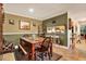 Comfortable dining area with rustic wood table, bench, and a view into the kitchen at 4006 Crockers Lake Blvd # 212, Sarasota, FL 34238