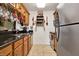 Functional kitchen featuring stainless steel appliances, wood cabinets, and granite countertops at 4006 Crockers Lake Blvd # 212, Sarasota, FL 34238