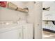 Functional laundry room with washer and dryer and overhead storage, providing convenience for laundry needs at 4006 Crockers Lake Blvd # 212, Sarasota, FL 34238