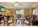 Cozy living room featuring comfortable seating and a sliding glass door with outdoor views at 4006 Crockers Lake Blvd # 212, Sarasota, FL 34238