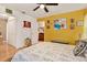 Bright main bedroom featuring a ceiling fan, an ensuite bathroom, and unique wall decor, enhancing its cozy charm at 4006 Crockers Lake Blvd # 212, Sarasota, FL 34238