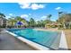 A refreshing pool with ample lounge chairs and shade, surrounded by lush landscaping, perfect for relaxation and recreation at 4006 Crockers Lake Blvd # 212, Sarasota, FL 34238