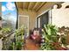 Inviting screened balcony with tile flooring and a variety of potted plants creating a relaxing outdoor retreat at 4006 Crockers Lake Blvd # 212, Sarasota, FL 34238