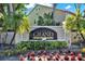 A clear view of the Vintage Grand on Palmer Ranch signage, beautifully landscaped with colorful flowers and mature plants at 4006 Crockers Lake Blvd # 212, Sarasota, FL 34238