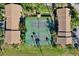 A top-down view showcasing well-maintained tennis courts situated within a beautiful community setting with ample greenery at 4006 Crockers Lake Blvd # 212, Sarasota, FL 34238