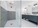 Modern bathroom featuring a large glass-enclosed shower with dual vanities at 405 28Th St, Holmes Beach, FL 34217