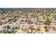 Panoramic aerial view of a property nestled in a quiet neighborhood with mature trees and proximity to the water at 4111 Moog Rd, Holiday, FL 34691