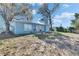 View of home's backyard with a patio, mature trees, and partial fencing at 4111 Moog Rd, Holiday, FL 34691