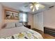 Cozy bedroom featuring a ceiling fan, closet, and wood flooring at 4111 Moog Rd, Holiday, FL 34691