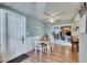 Bright dining area with a table and chairs, wood floors, and access to the outdoor patio at 4111 Moog Rd, Holiday, FL 34691