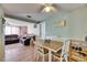 Charming dining area with table, chairs, wood floors, and comfortable access to both the kitchen and living room at 4111 Moog Rd, Holiday, FL 34691