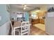 Inviting dining area with a table and chairs, wood floors, and a view into the kitchen at 4111 Moog Rd, Holiday, FL 34691