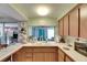 Well-lit kitchen featuring a breakfast bar, sink with window, and a view into another living space at 4111 Moog Rd, Holiday, FL 34691