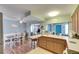 Open-concept kitchen with breakfast bar flowing into the dining room with an eye catching blue brick wall at 4111 Moog Rd, Holiday, FL 34691