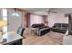 Inviting living room with a comfortable leather sofa, wood floors, and a bright, airy atmosphere at 4111 Moog Rd, Holiday, FL 34691