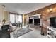 Living room with a charming brick fireplace, neutral walls, and tile floors at 4111 Moog Rd, Holiday, FL 34691