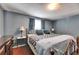 Spacious main bedroom with laminate floors, large window, and cozy furnishings create a comfortable retreat at 4111 Moog Rd, Holiday, FL 34691
