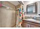Bathroom shower with tile surround and a coordinating shower curtain at 4111 Moog Rd, Holiday, FL 34691