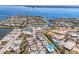 Aerial view of waterfront community with canal access, tennis courts, and lush landscaping at 423 62Nd St, Holmes Beach, FL 34217
