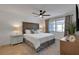 Comfortable bedroom with a wooden headboard, ceiling fan, and bright natural light from the large window at 423 62Nd St, Holmes Beach, FL 34217