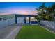 Charming single-story home with a manicured lawn, attached garage, and beautiful landscaping at 423 62Nd St, Holmes Beach, FL 34217
