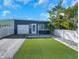 Charming single-story home featuring a well-manicured lawn, fenced yard, and attached garage at 423 62Nd St, Holmes Beach, FL 34217