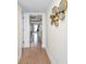 Hallway with neutral tile flooring and a decorative wall mirror at 423 62Nd St, Holmes Beach, FL 34217
