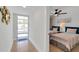 Hallway leading into bright bedroom with twin beds, a ceiling fan, and coastal decor at 423 62Nd St, Holmes Beach, FL 34217