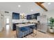 Kitchen featuring an island with seating, stainless steel appliances, and custom cabinetry at 423 62Nd St, Holmes Beach, FL 34217