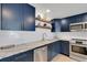Bright kitchen featuring custom cabinets, stainless steel appliances, and stone countertops at 423 62Nd St, Holmes Beach, FL 34217