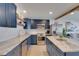 Well-equipped kitchen with island, stainless steel appliances, custom cabinets and stone countertops at 423 62Nd St, Holmes Beach, FL 34217