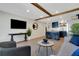 Open living room with tile floors, recessed lights, open to the kitchen, and wood beam at 423 62Nd St, Holmes Beach, FL 34217