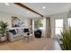 Cozy living room showcases a decorative beam, comfortable seating, and a large window for natural light at 423 62Nd St, Holmes Beach, FL 34217