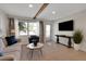 Inviting living room featuring a decorative beam, neutral tones, and a flat-screen TV for entertainment at 423 62Nd St, Holmes Beach, FL 34217