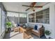 Cozy sunroom with wicker furniture, ceiling fan, and view of the backyard at 423 62Nd St, Holmes Beach, FL 34217