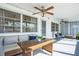 Inviting sunroom with comfortable seating, wicker table, and tranquil ambiance at 423 62Nd St, Holmes Beach, FL 34217